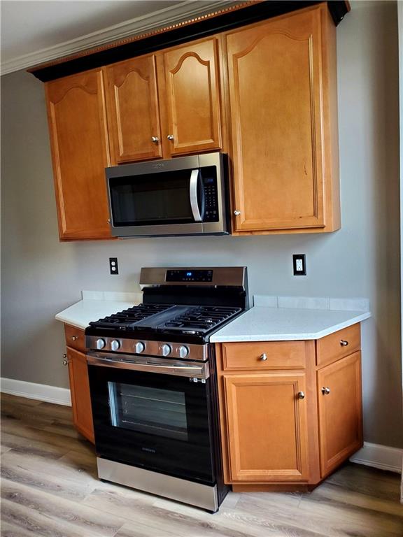 905 Deely Street Pittsburgh, PA 15217 - Photo 10 of 19 a kitchen with wooden cabinets and a stove top oven