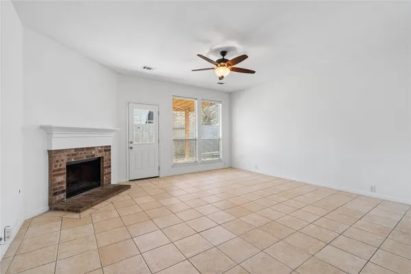 a view of empty room with fireplace