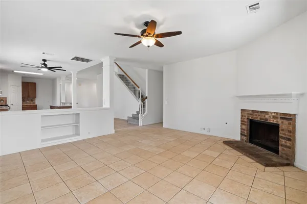 a view of an empty room and fire place
