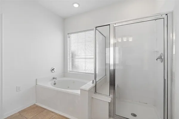 a bathroom with a bathtub and shower