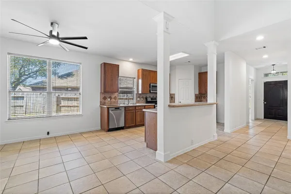 a view of kitchen with windows and refrigerator