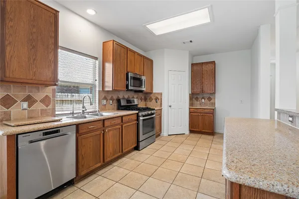 a kitchen with a sink appliances and cabinets