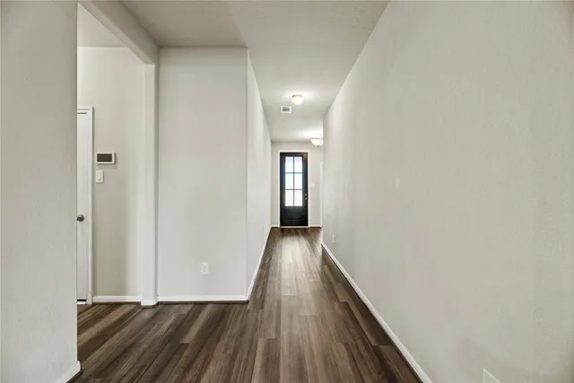 a view of hallway with wooden floor