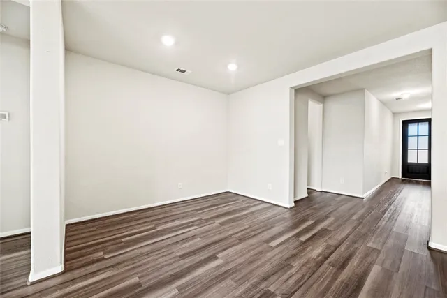 a view of kitchen with wooden floor and electronic appliances