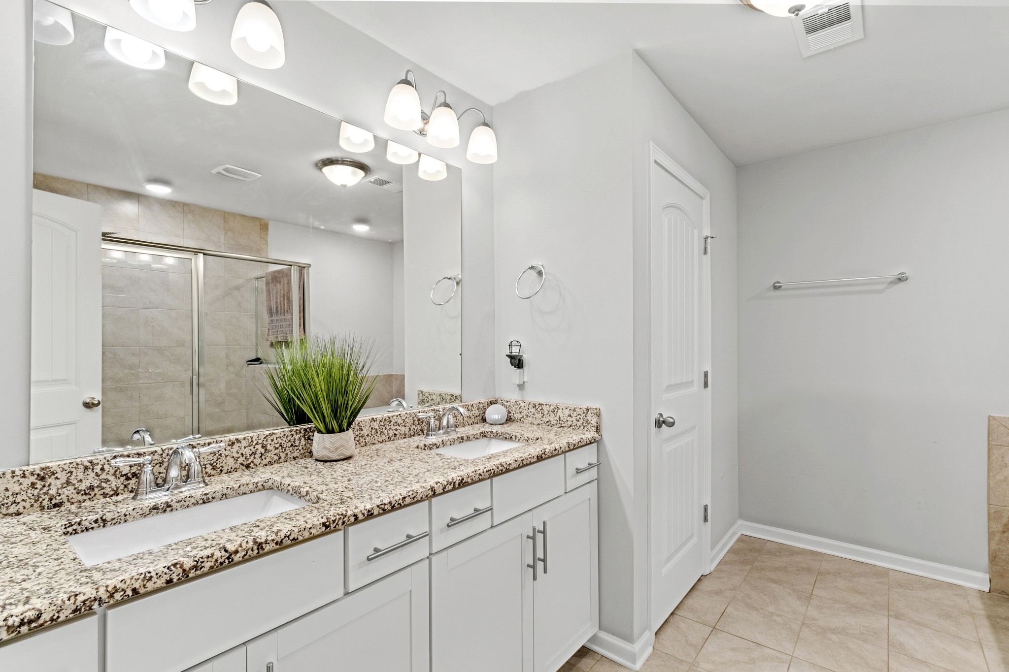 1053 Enclave Avenue Pleasant View, TN 37146 - Photo 14 of 27 a bathroom with a granite countertop sink a large mirror and vanity