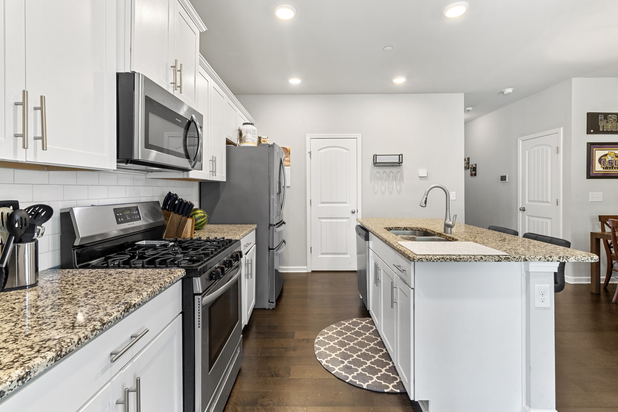1053 Enclave Avenue Pleasant View, TN 37146 - Photo 7 of 27 a kitchen with stainless steel appliances granite countertop a stove a refrigerator a sink and dishwasher