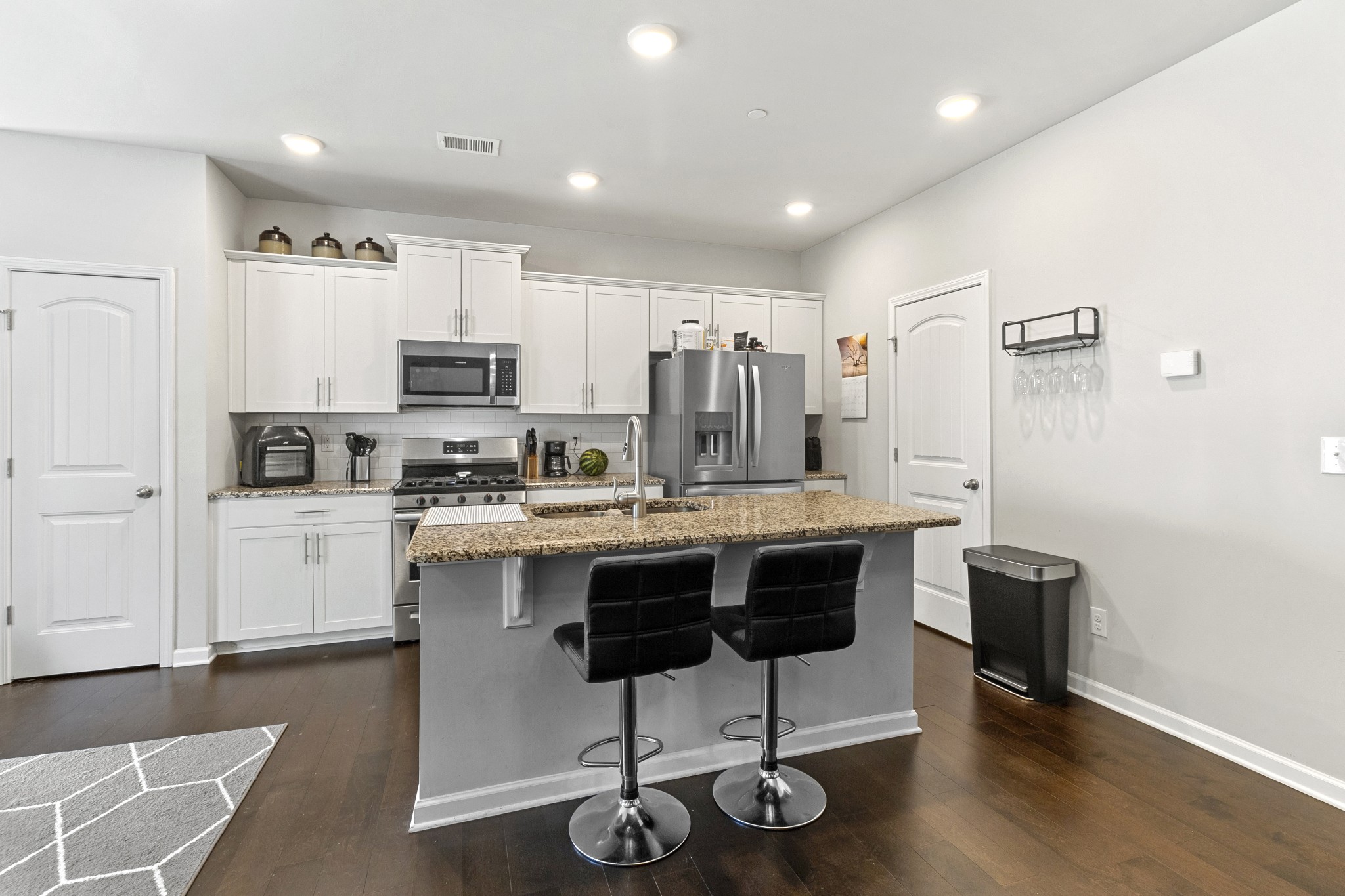1053 Enclave Avenue Pleasant View, TN 37146 - Photo 8 of 27 a kitchen with kitchen island a cabinets and wooden floor