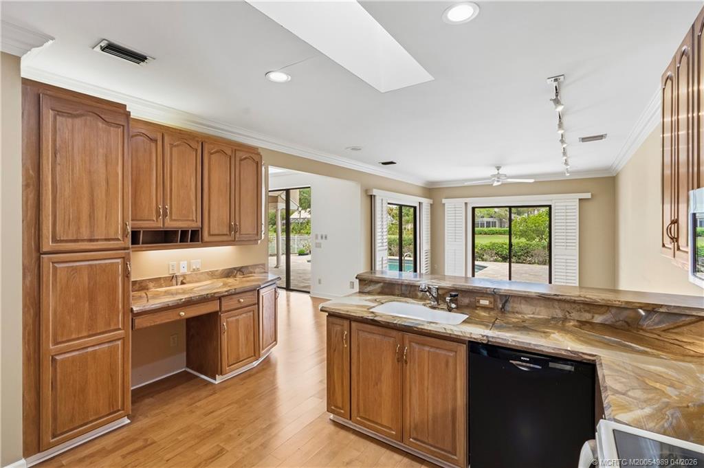 6273 Southeast Baltusrol Terrace Stuart, FL 34997 - Photo 18 of 68 a kitchen with stainless steel appliances granite countertop a sink stove and refrigerator