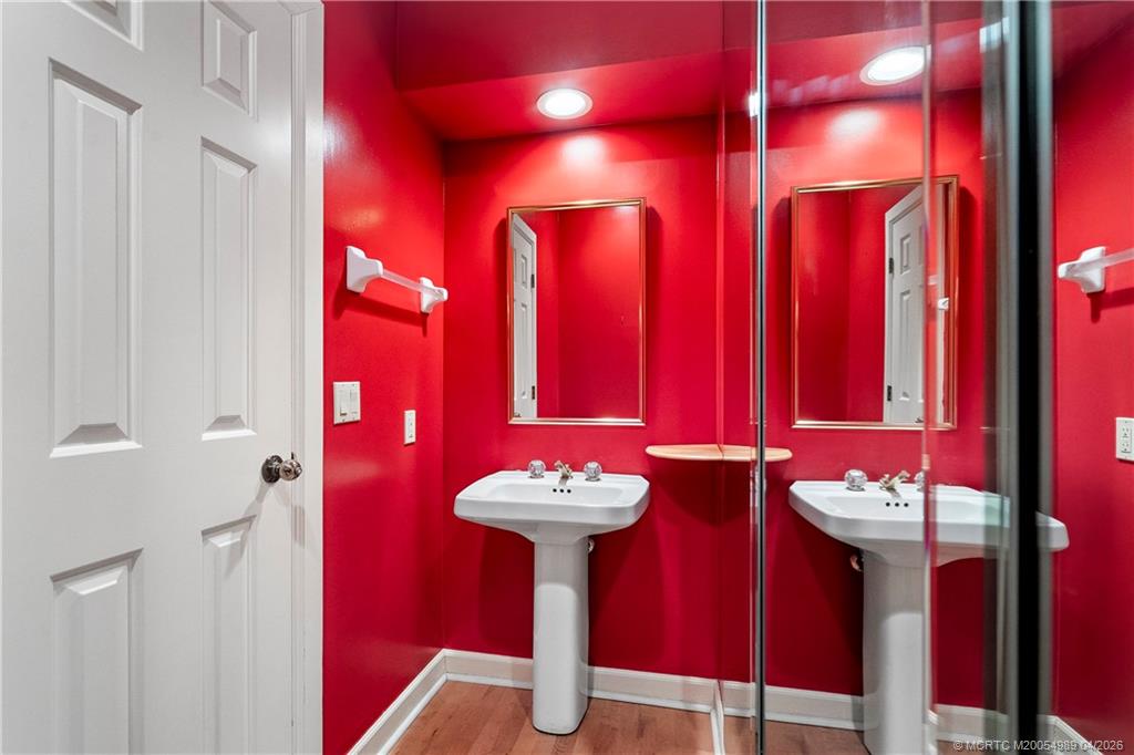 6273 Southeast Baltusrol Terrace Stuart, FL 34997 - Photo 21 of 68 a bathroom with a sink and a mirror