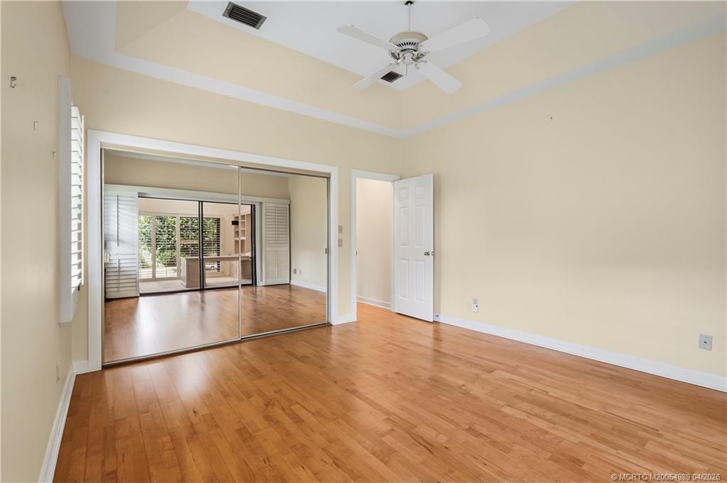 6273 Southeast Baltusrol Terrace Stuart, FL 34997 - Photo 28 of 68 wooden floor in an empty room with a window