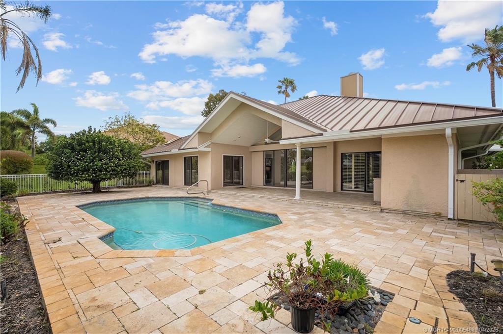 6273 Southeast Baltusrol Terrace Stuart, FL 34997 - Photo 50 of 68 a front view of a house with swimming pool