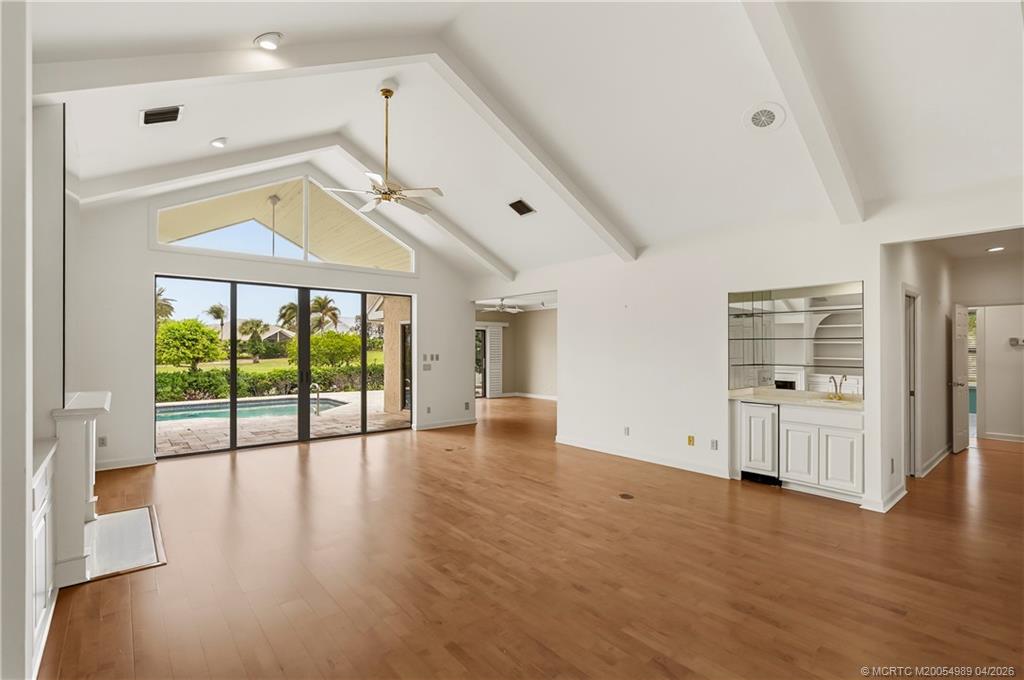 6273 Southeast Baltusrol Terrace Stuart, FL 34997 - Photo 5 of 68 a view of empty room with wooden floor and fan