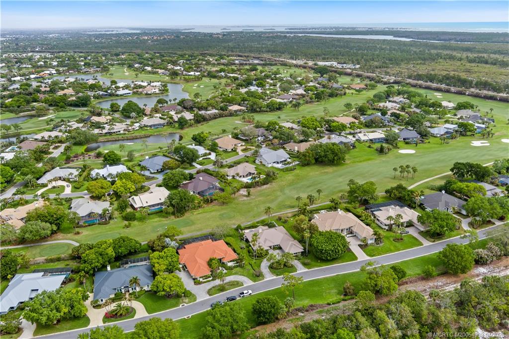 6273 Southeast Baltusrol Terrace Stuart, FL 34997 - Photo 62 of 68 an aerial view of residential houses with outdoor space and trees