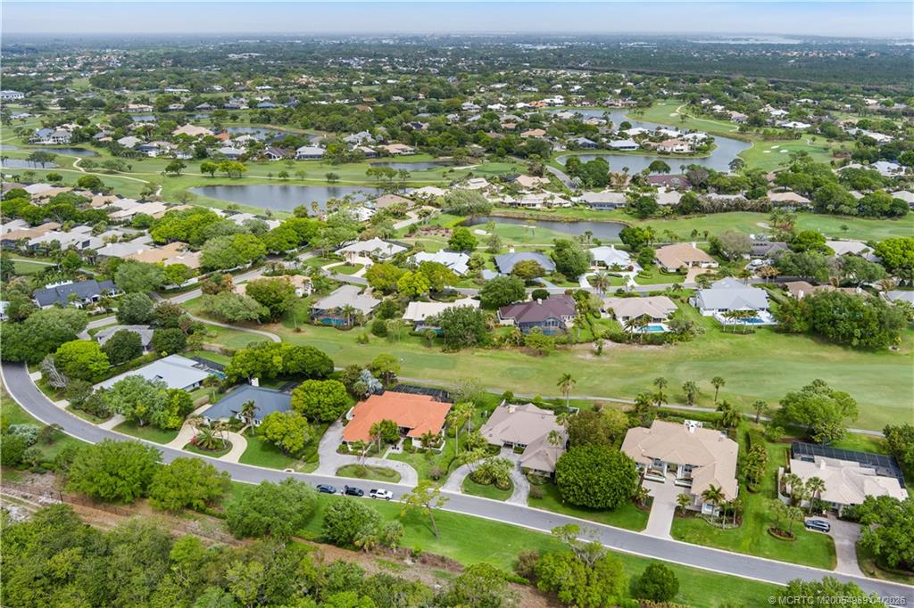 6273 Southeast Baltusrol Terrace Stuart, FL 34997 - Photo 64 of 68 an aerial view of a houses with outdoor space and lake view