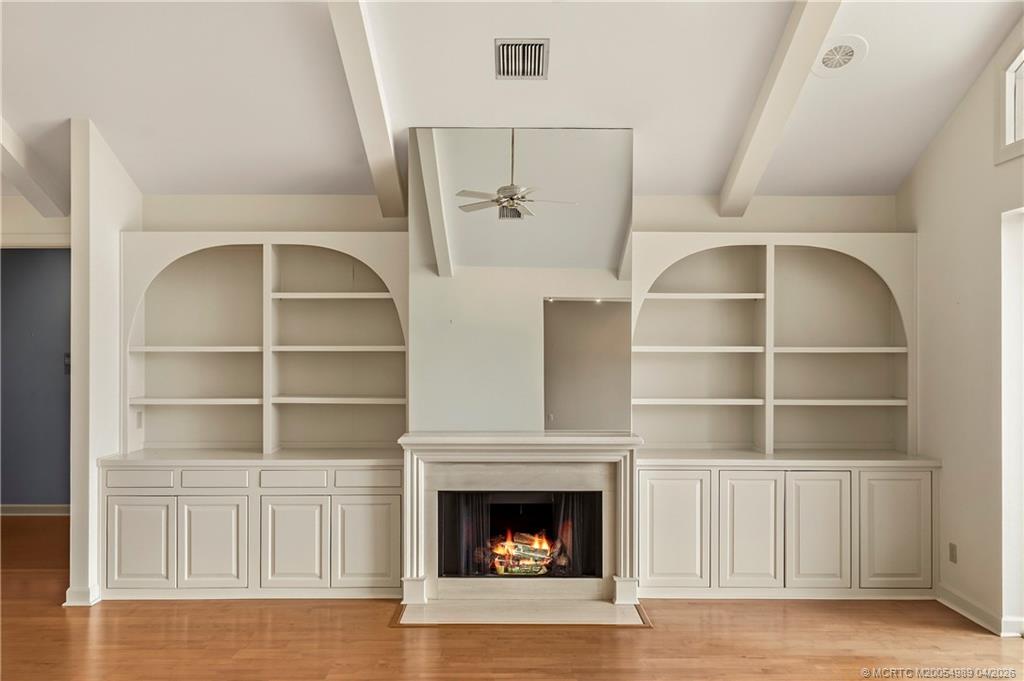 6273 Southeast Baltusrol Terrace Stuart, FL 34997 - Photo 8 of 68 a living room with a fireplace cabinet and a fireplace