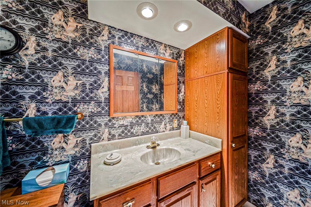 8801 Bunker Road Orwell, OH 44076 - Photo 35 of 50 Bathroom with wallpapered walls and vanity