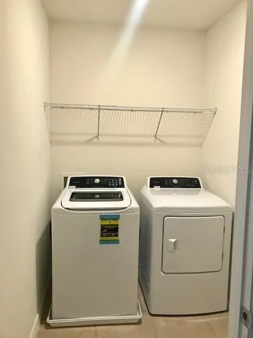 an aerial view of a house with a yard and lake view