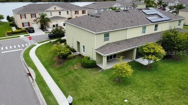a aerial view of a house with a yard table and chairs