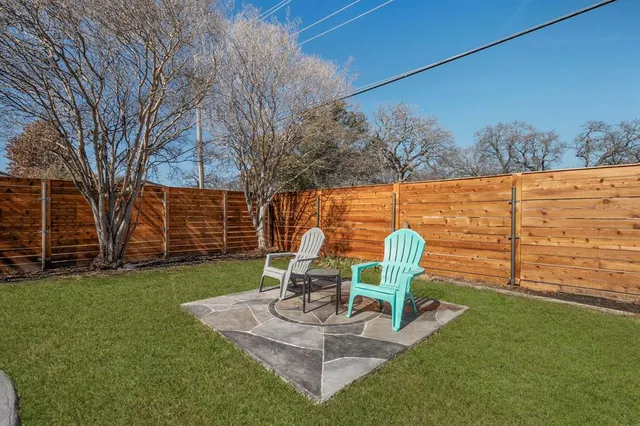 a view of a table and chairs in the garden