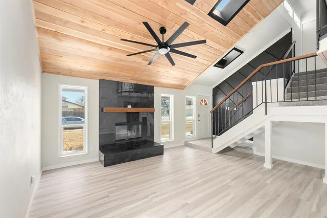 a view of a hallway with wooden floor and entryway