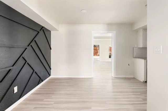 a view of an empty room and wooden floor