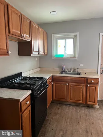 a kitchen with granite countertop cabinets stainless steel appliances and a sink