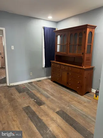 a bedroom with a dresser and a mirror
