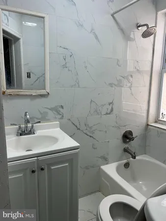 a bathroom with a sink toilet and a mirror