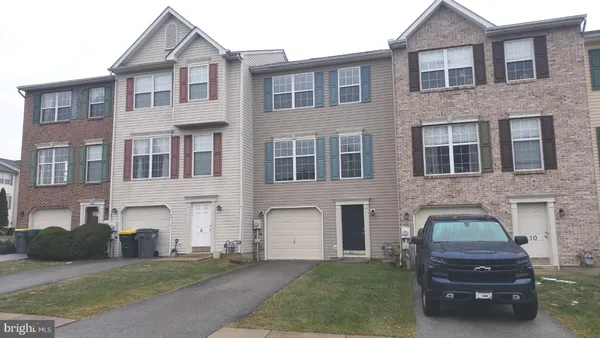 a car parked in front of a brick house