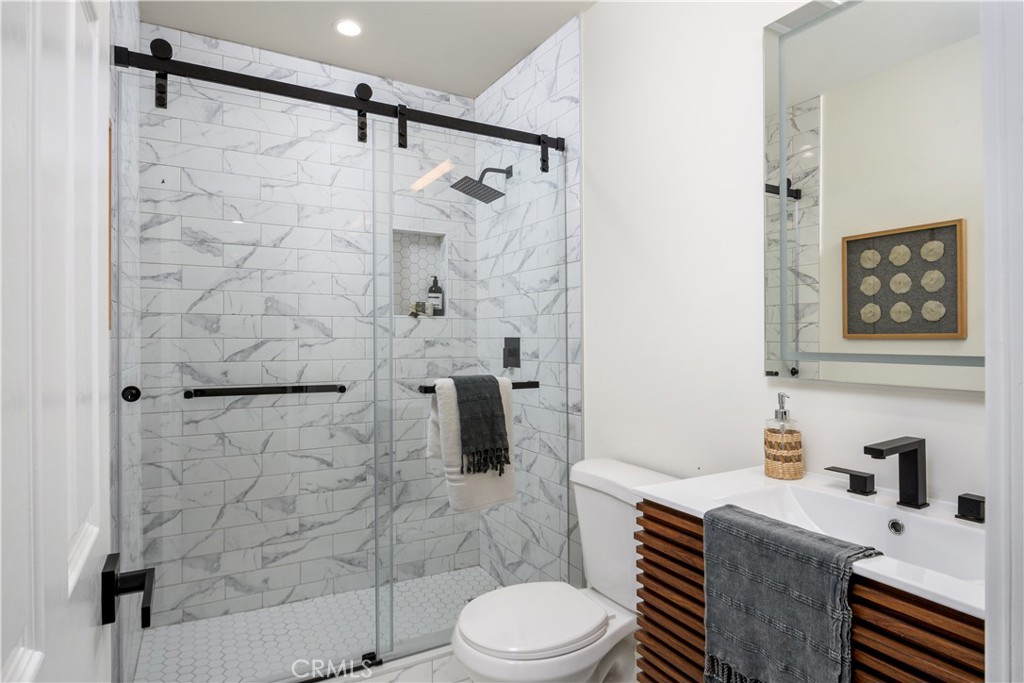 2531 North Studebaker Road Long Beach, CA 90815 - Photo 13 of 34 a bathroom with a sink toilet and shower