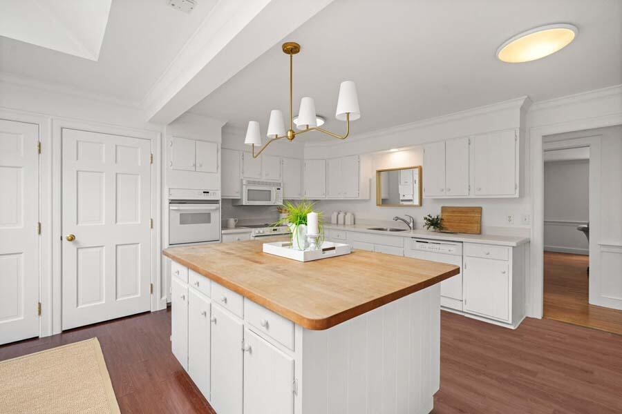 201 Smoke Valley Road Osterville, MA 02655 - Photo 18 of 48 a kitchen with a center island wooden floor and a refrigerator