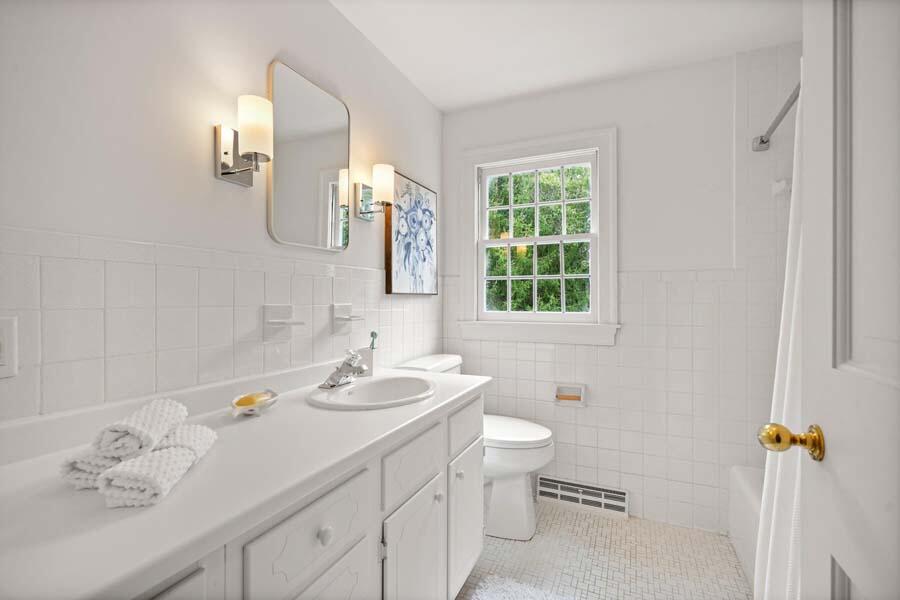 201 Smoke Valley Road Osterville, MA 02655 - Photo 32 of 48 a bathroom with a toilet sink and mirror