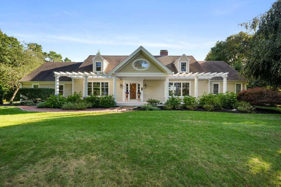 201 Smoke Valley Road Osterville, MA 02655 - Photo 4 of 48 a front view of a house with a garden