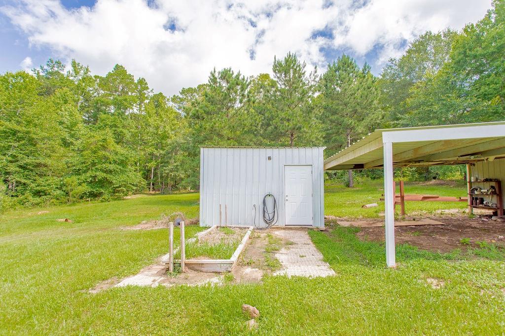 636 Roberson Road Hallsville, TX 75650 - Photo 11 of 36 a view of a backyard with swimming pool