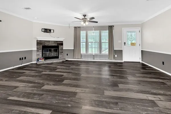 a view of livingroom with fireplace window and wooden floor
