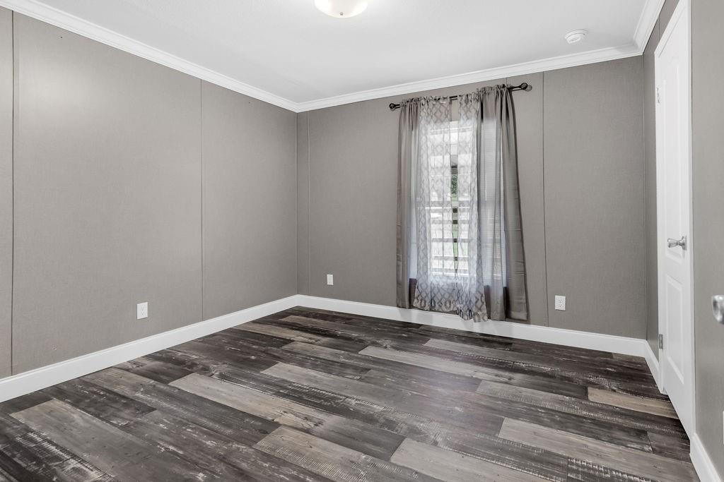 636 Roberson Road Hallsville, TX 75650 - Photo 24 of 36 a view of an empty room with wooden floor and a window