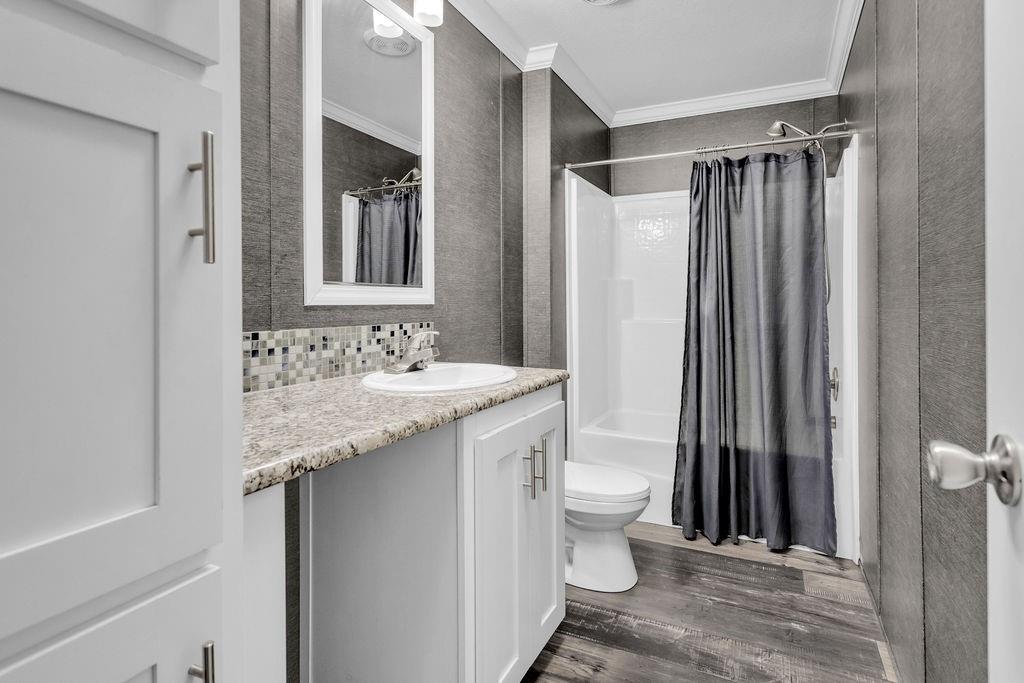 636 Roberson Road Hallsville, TX 75650 - Photo 25 of 36 a bathroom with a granite countertop sink toilet and shower