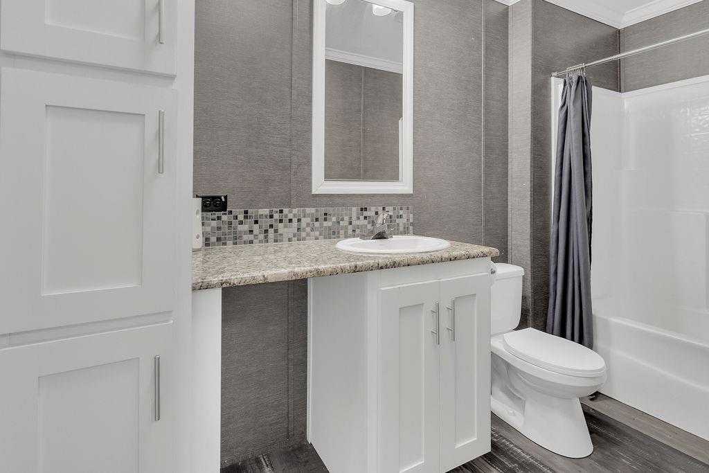 636 Roberson Road Hallsville, TX 75650 - Photo 26 of 36 a bathroom with a sink toilet and shower