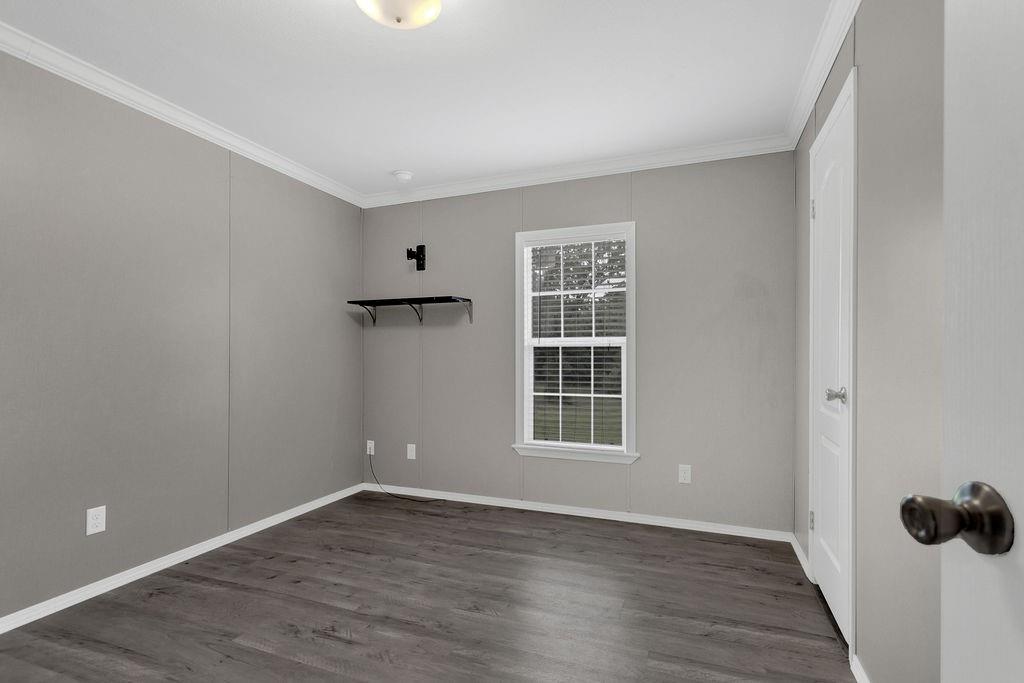 636 Roberson Road Hallsville, TX 75650 - Photo 31 of 36 an empty room with wooden floor and windows