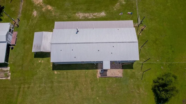 an aerial view of house with yard swimming pool and outdoor seating