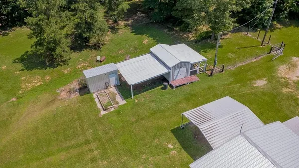 an aerial view of a house with swimming pool garden and patio