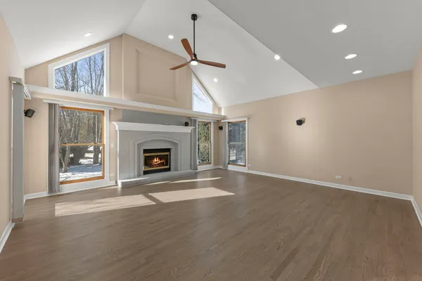 a view of an empty room with a fireplace and a window