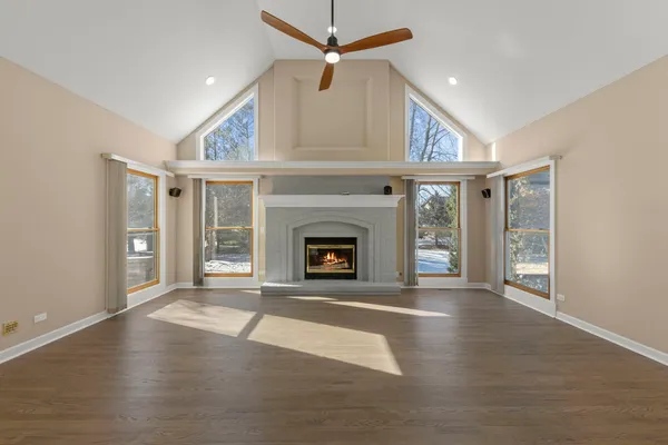 a view of an empty room with window and fire place
