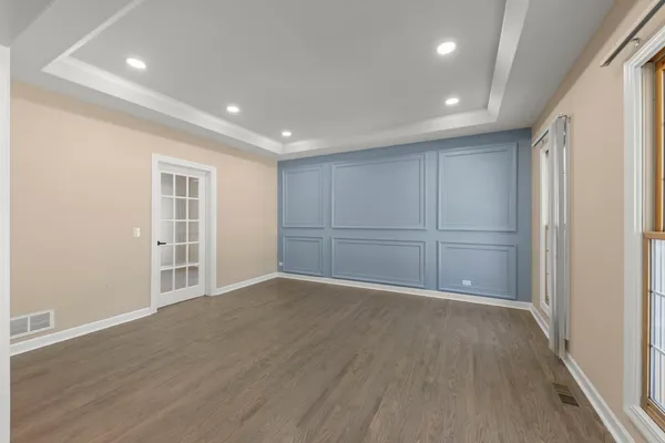 a view of an empty room with wooden floor