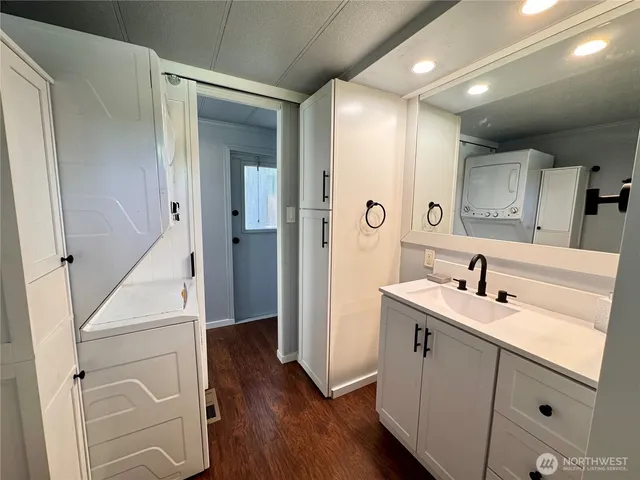 a bathroom with a sink a toilet and a large mirror