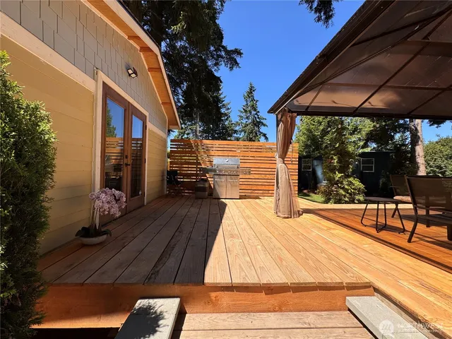 a view of a patio with table and chairs under an umbrella