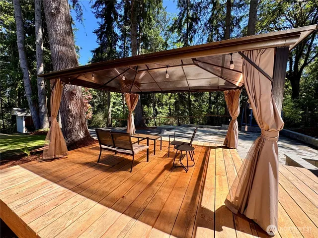 a view of a house with a yard patio and fire pit