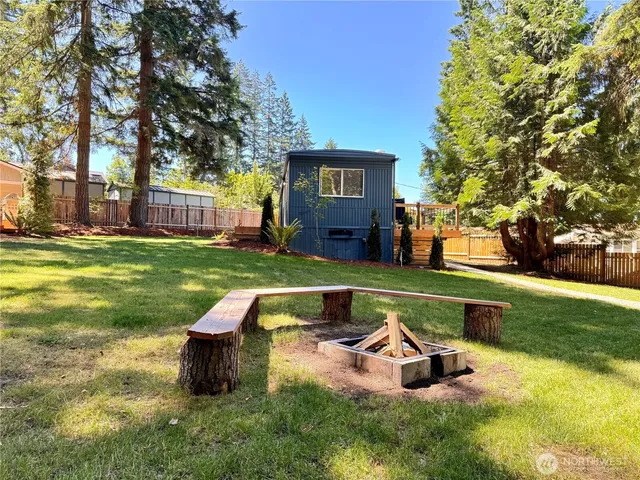 a swimming pool with outdoor seating and yard