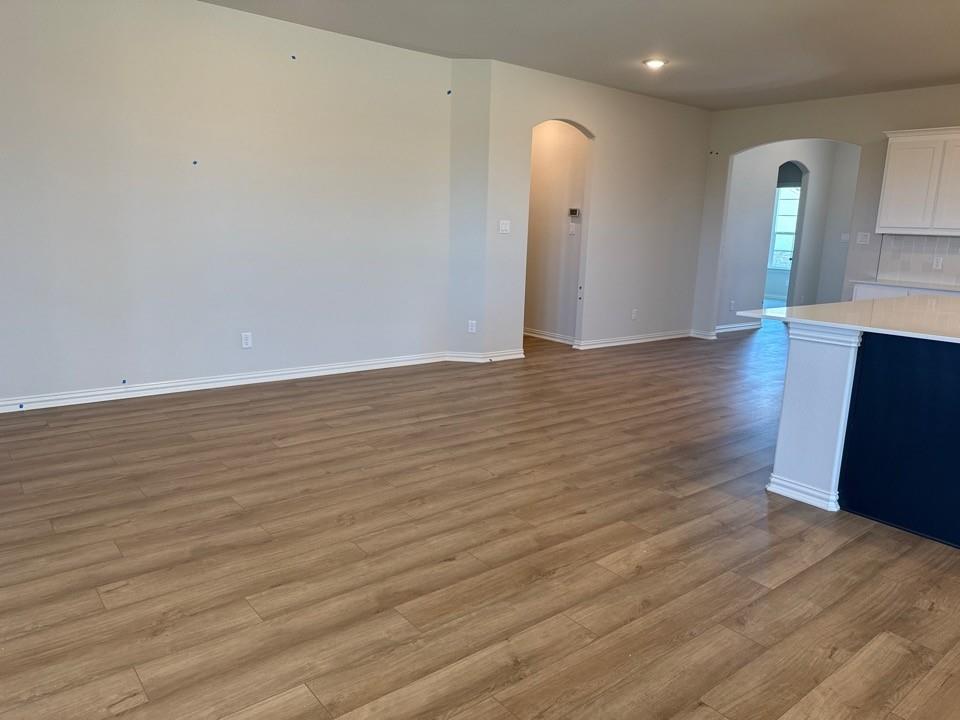 1325 Frio Drive Springtown, TX 76082 - Photo 5 of 10 a view of an empty room with wooden floor and a window