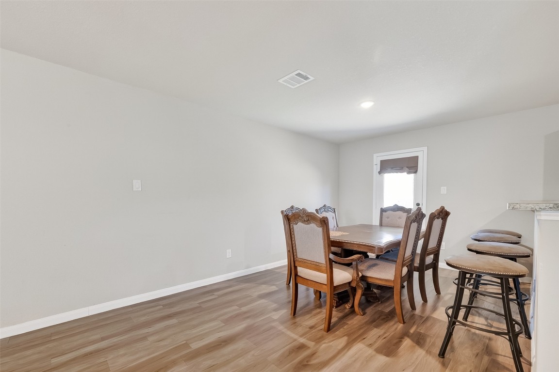 2516 Boss Street La Marque, TX 77568 - Photo 14 of 46 a view of a dining room with furniture and wooden floor